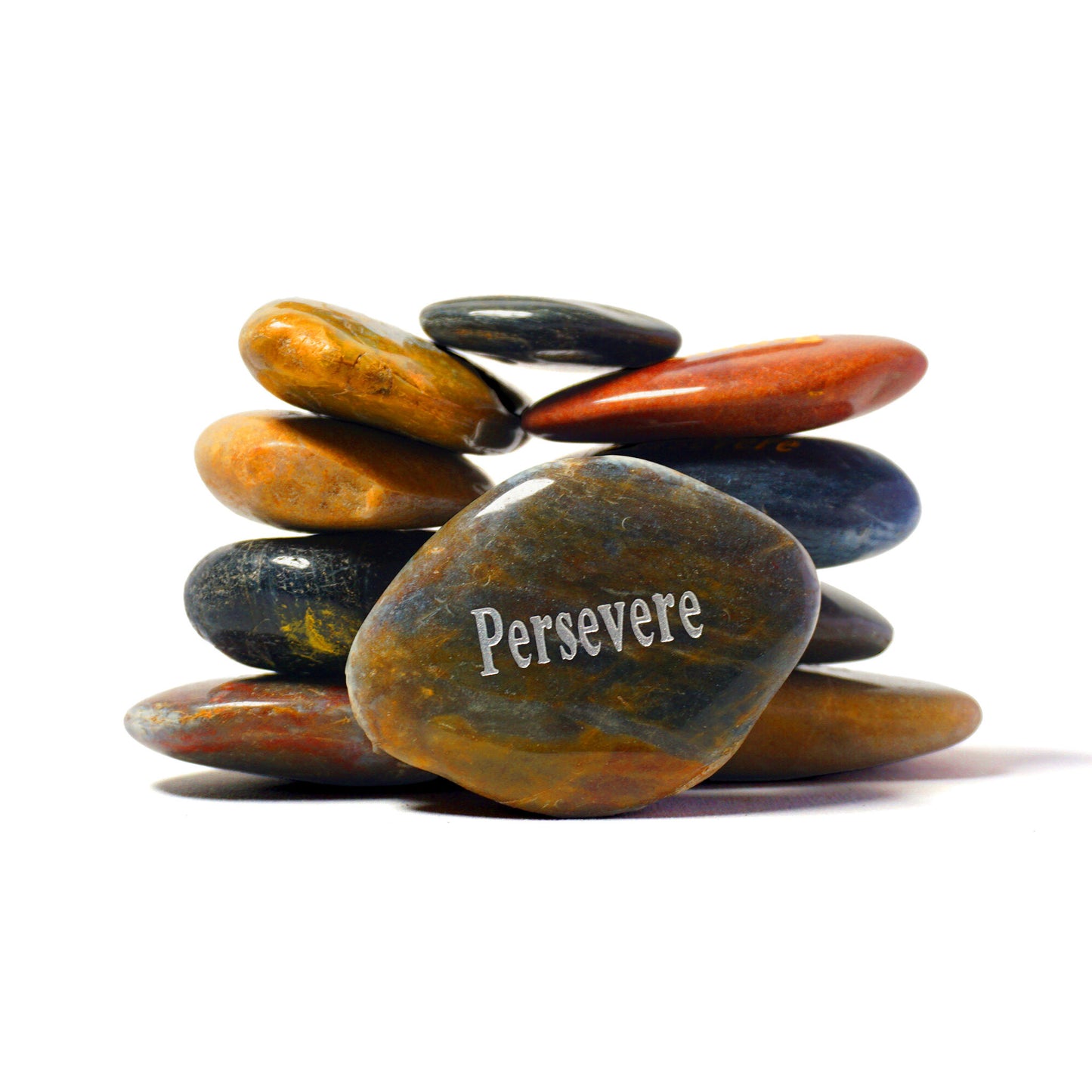 Stack of multicolored stones with 'Persevere' engraved on one stone against a white background