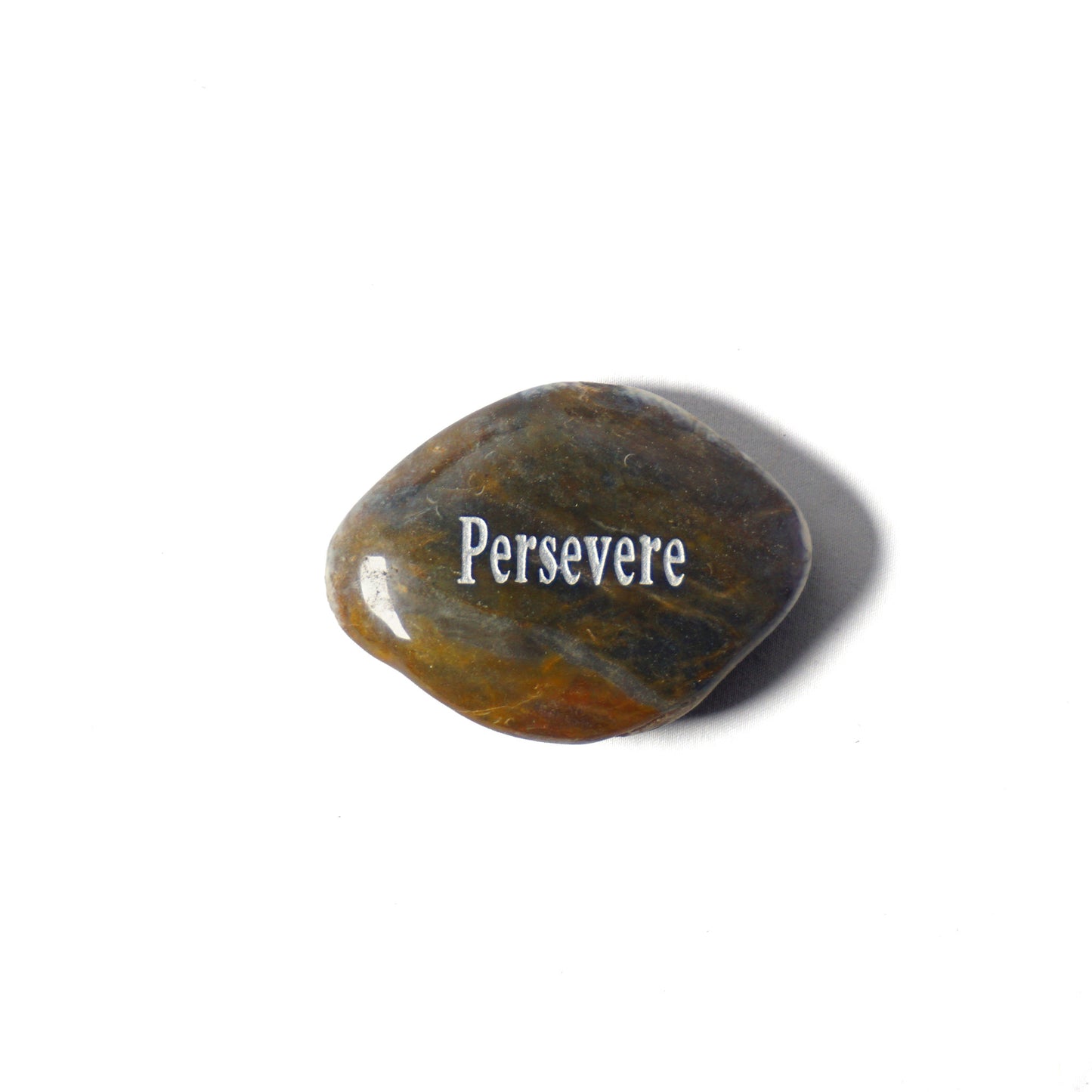 Rounded stone with 'Persevere' engraved on a white background