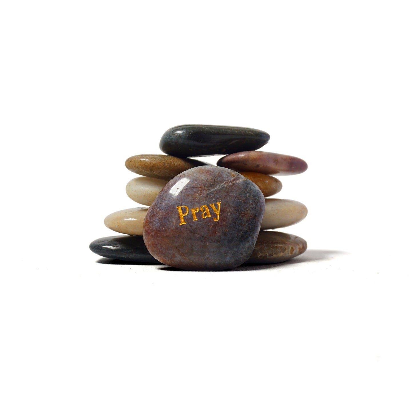 Stack of stones with 'Pray' engraved on one stone against a white background