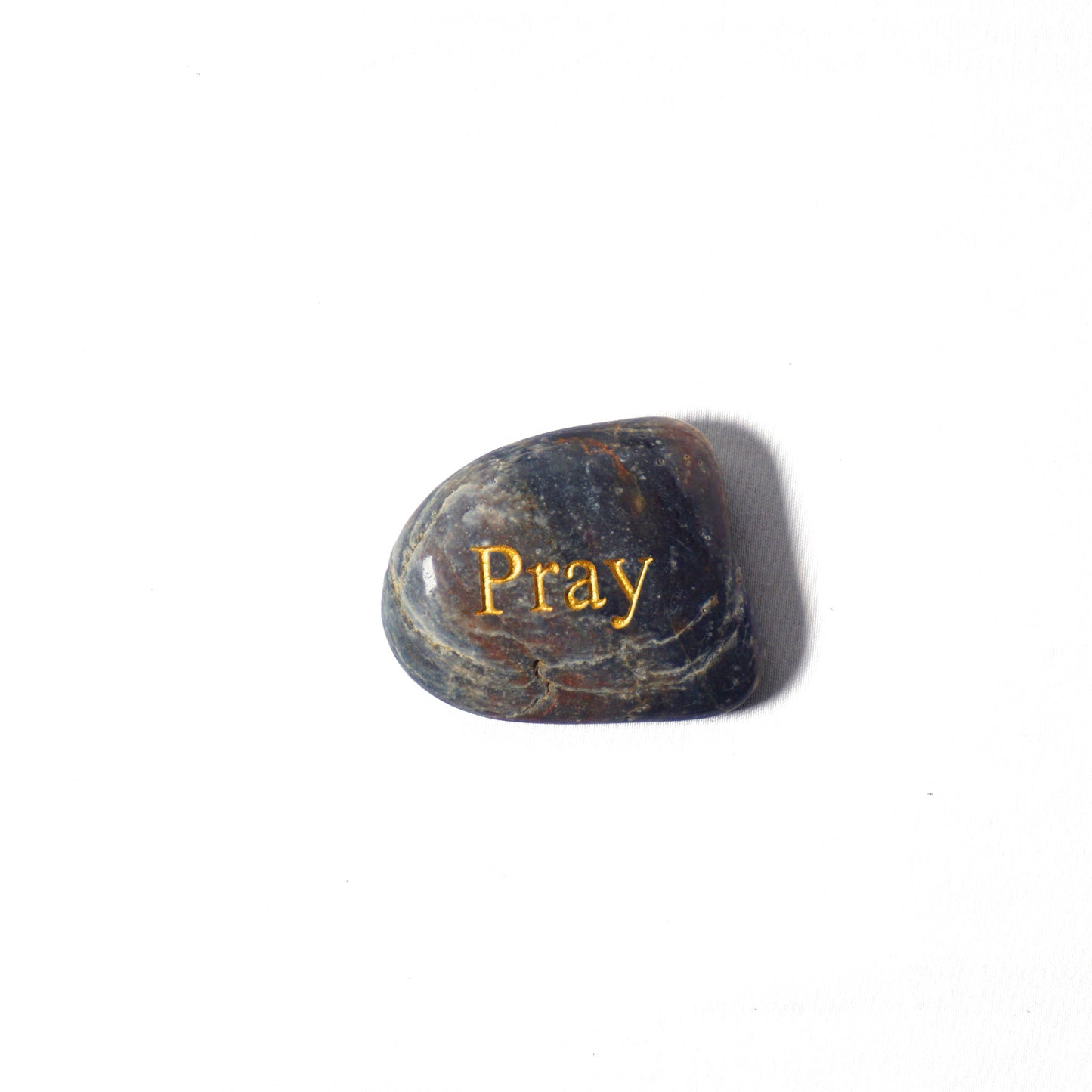 Rounded stone with 'Pray' engraved on a white background