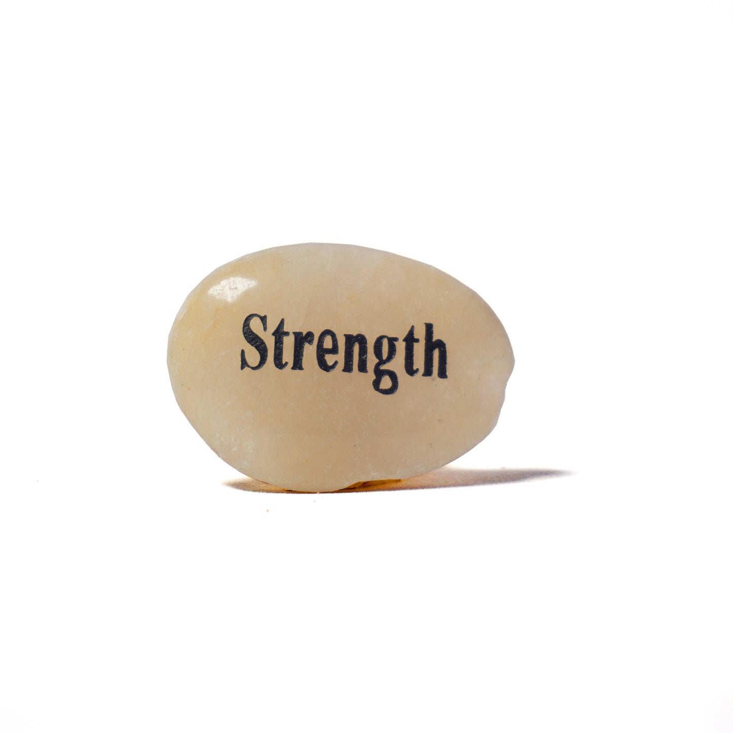 Rounded stone with 'Strength' engraved on a white background