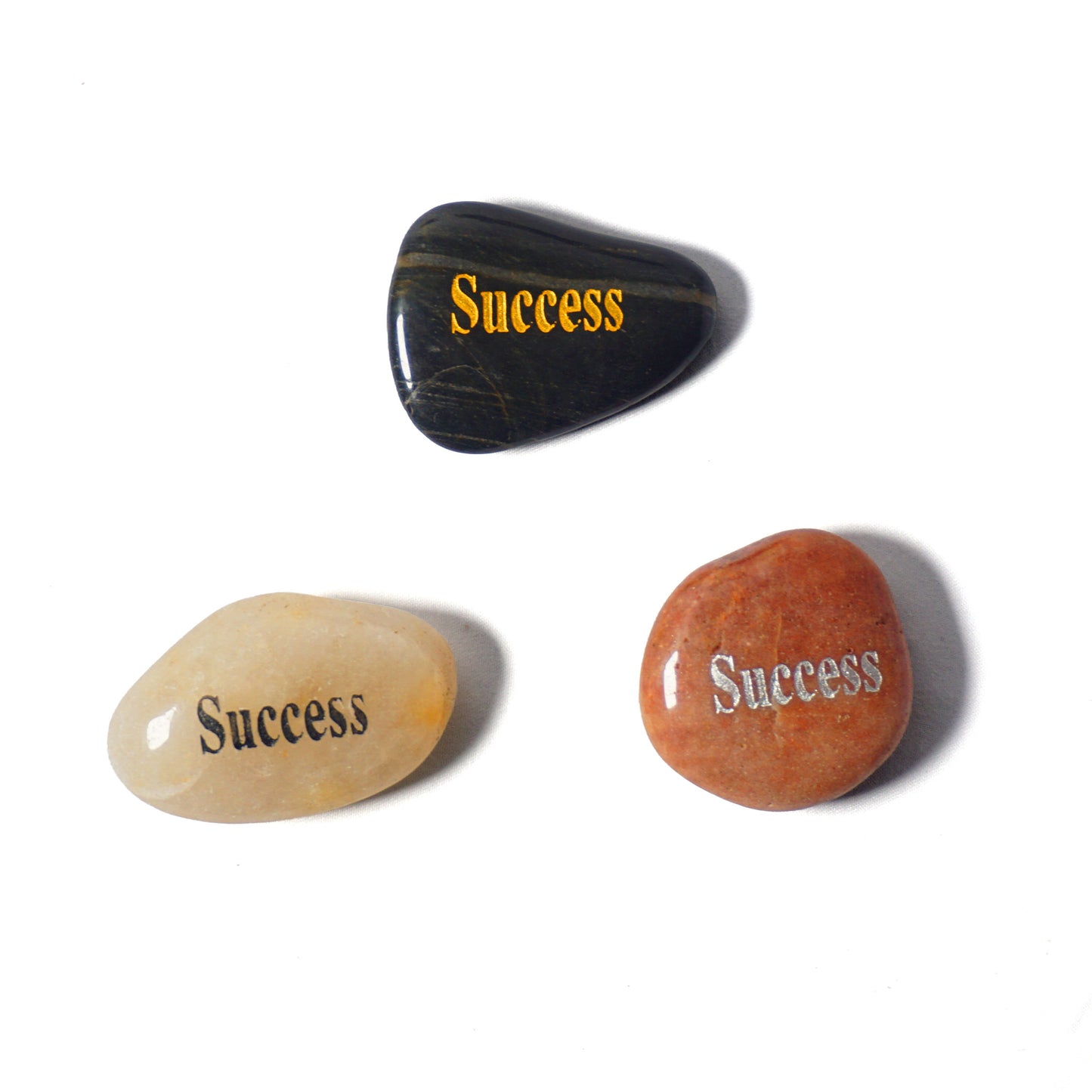 Three stones with 'Success' engraved on them on a white background
