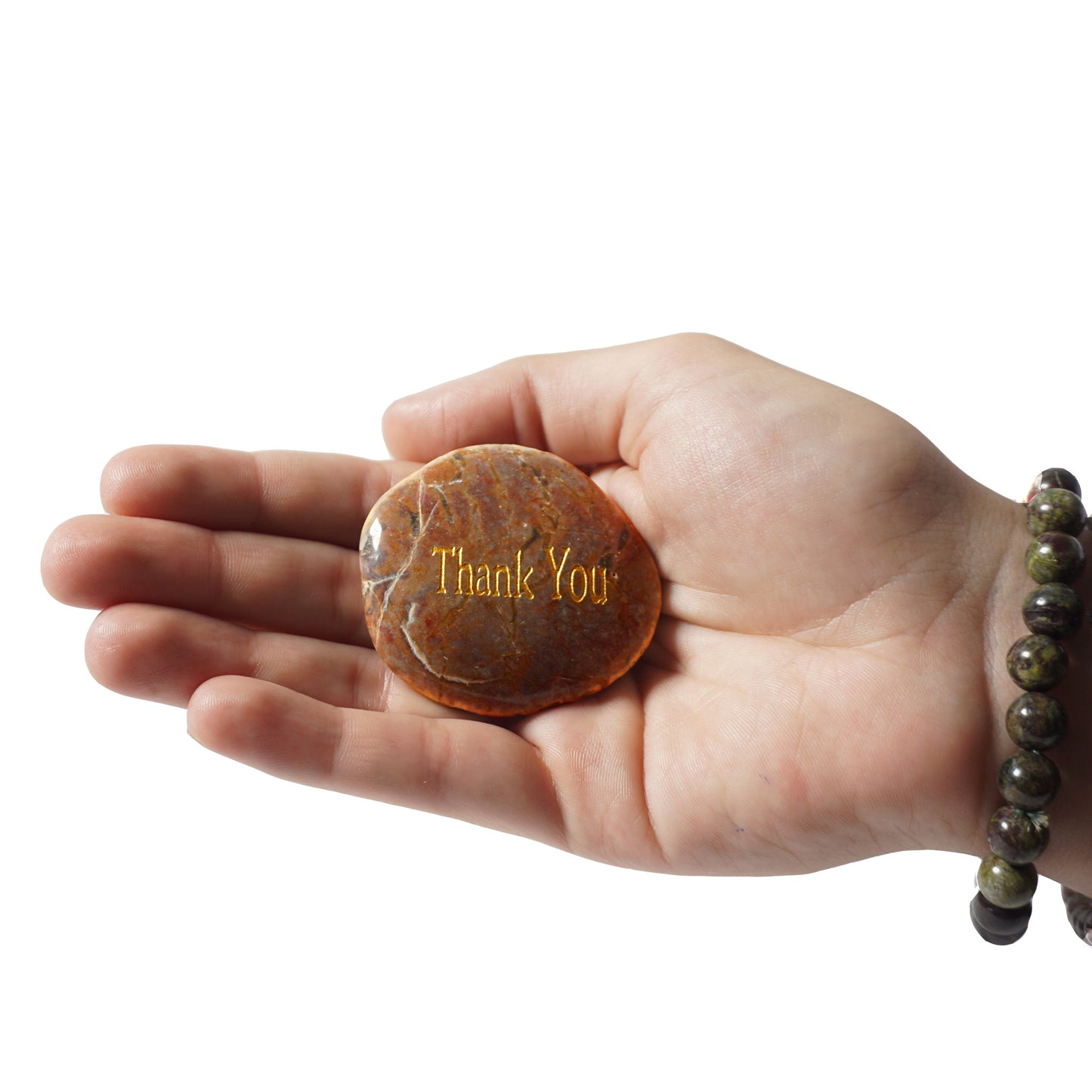 Hand holding a stone with 'Thank You' engraving on a white background
