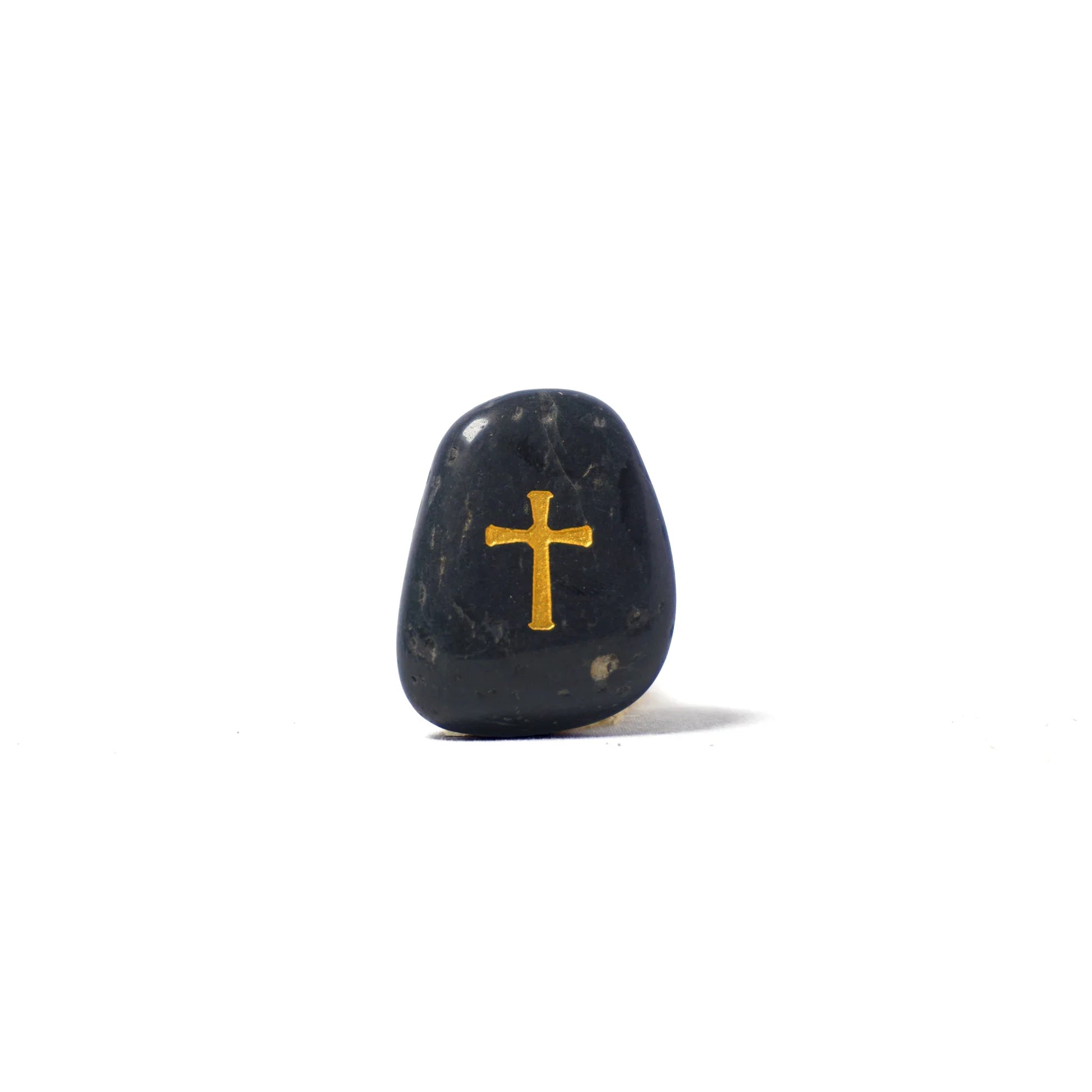 Black stone with a gold cross on a white background