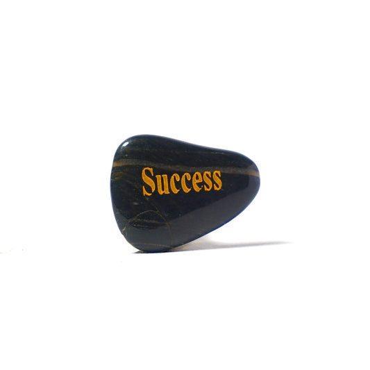 Black stone with 'Success' engraved on a white background