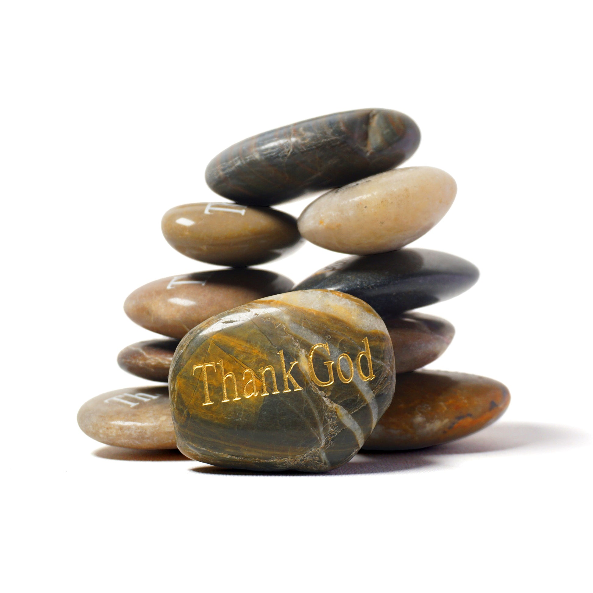 Stack of stones with 'Thank God' engraved on a white background