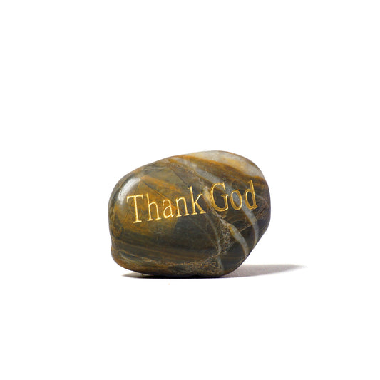 Decorative stone with 'Thank God' engraving on a white background