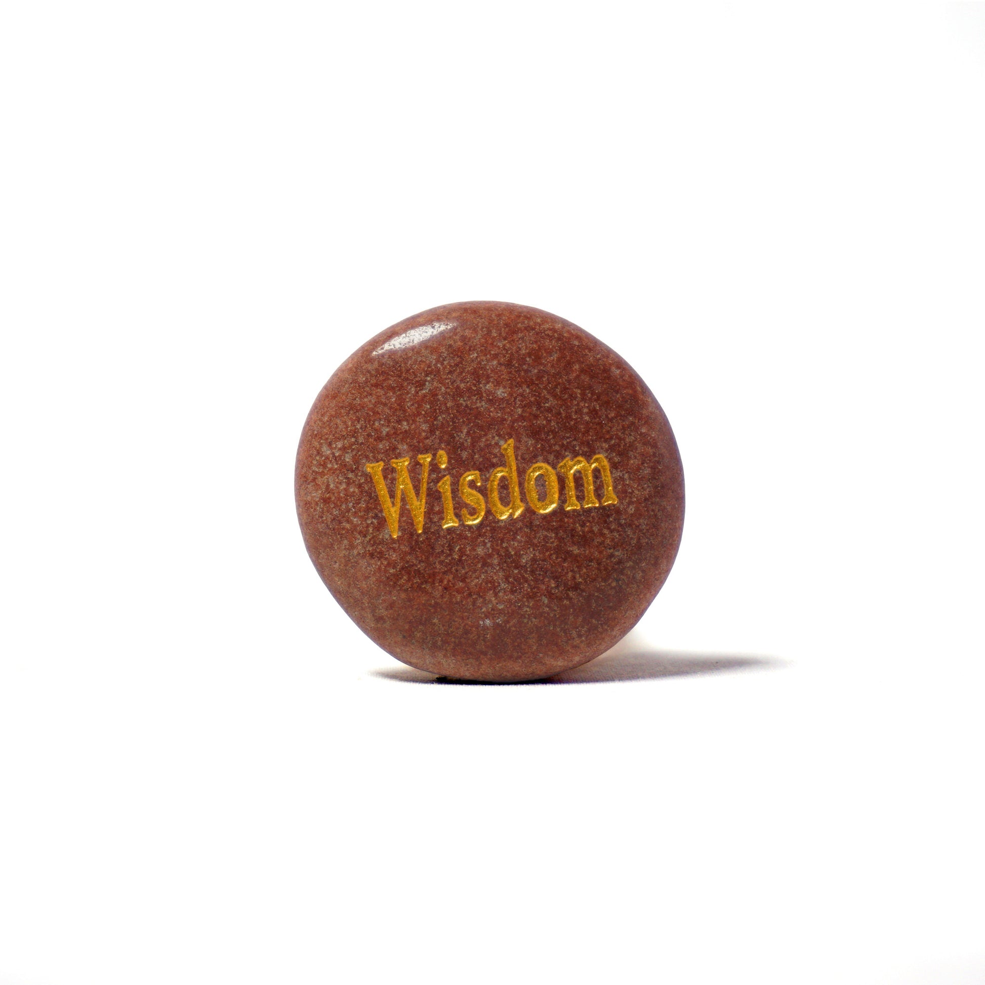 Round brown stone with 'Wisdom' engraved on a white background