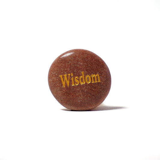Round brown stone with 'Wisdom' engraved on a white background