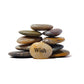 Stack of stones with a yellow stone in the foreground displaying the word 'Wish' on a white background