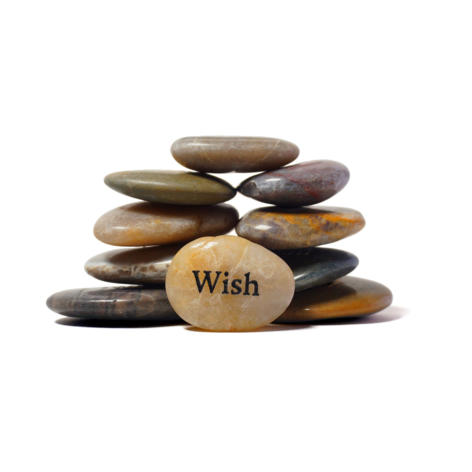 Stack of stones with a yellow stone in the foreground displaying the word 'Wish' on a white background