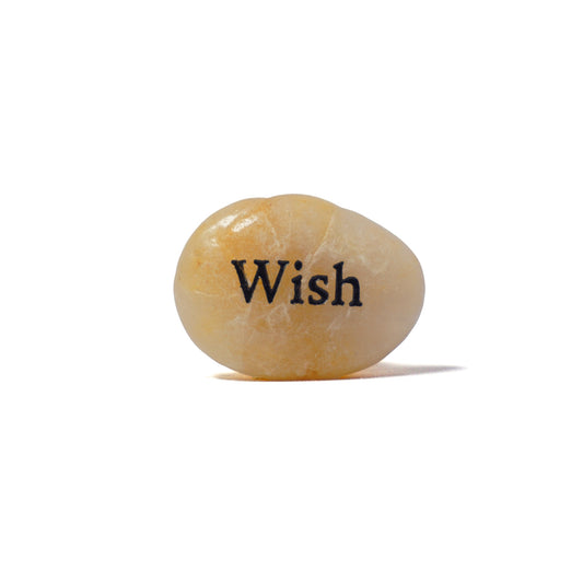 Decorative stone with 'Wish' engraved on a white background