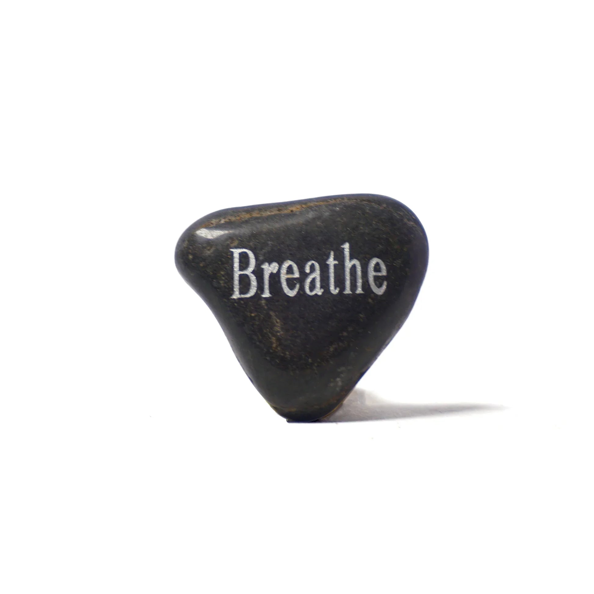Black stone with 'Breathe' engraved on a white background