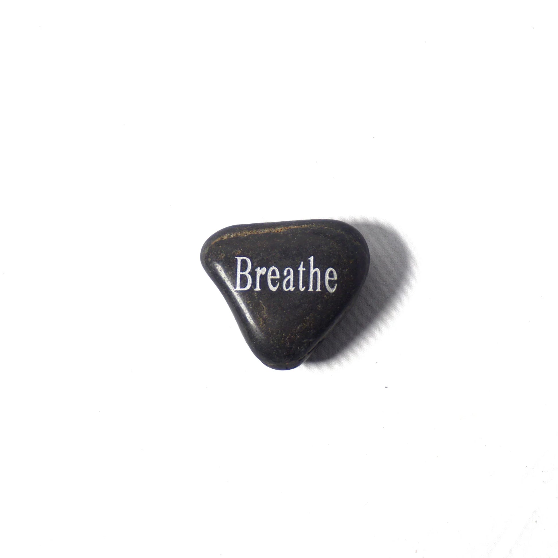 Black stone with 'Breathe' engraved on a white background