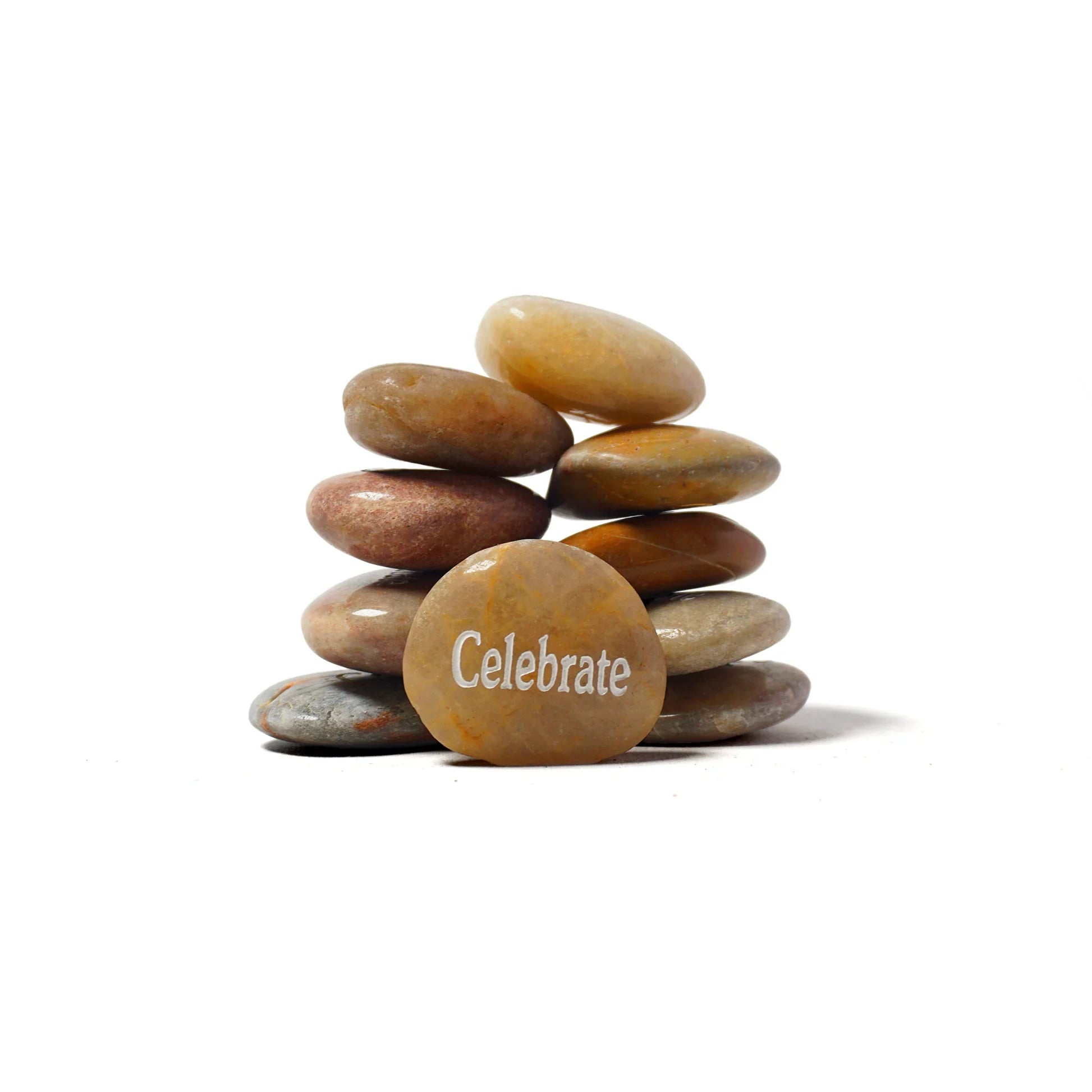 Stack of stones with 'Celebrate' engraved on a white background