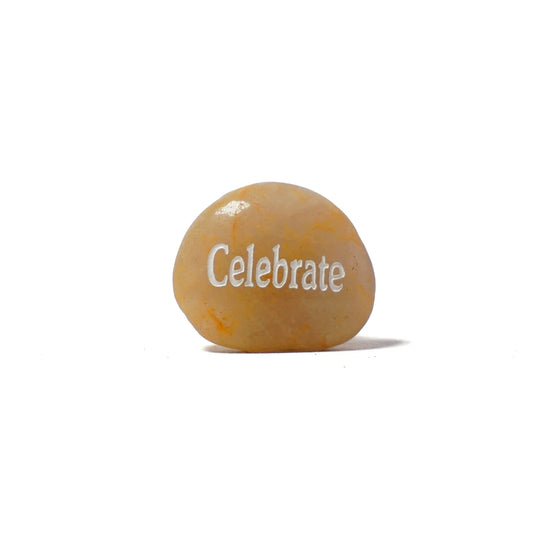 Round stone with 'Celebrate' engraved on a white background