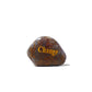 Rusty metal rock with 'Change' engraved on a white background