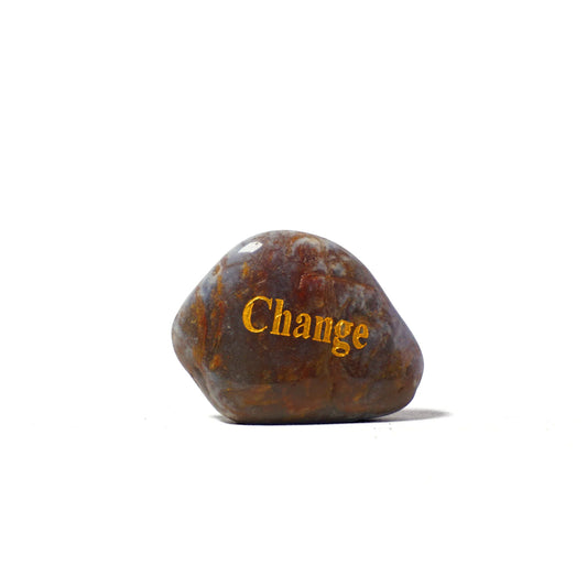 Rusty metal rock with 'Change' engraved on a white background