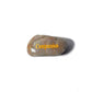 Rounded stone with 'Compassion' engraved on a white background