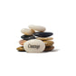 Stack of stones with a white stone in the center labeled 'Courage' on a white background
