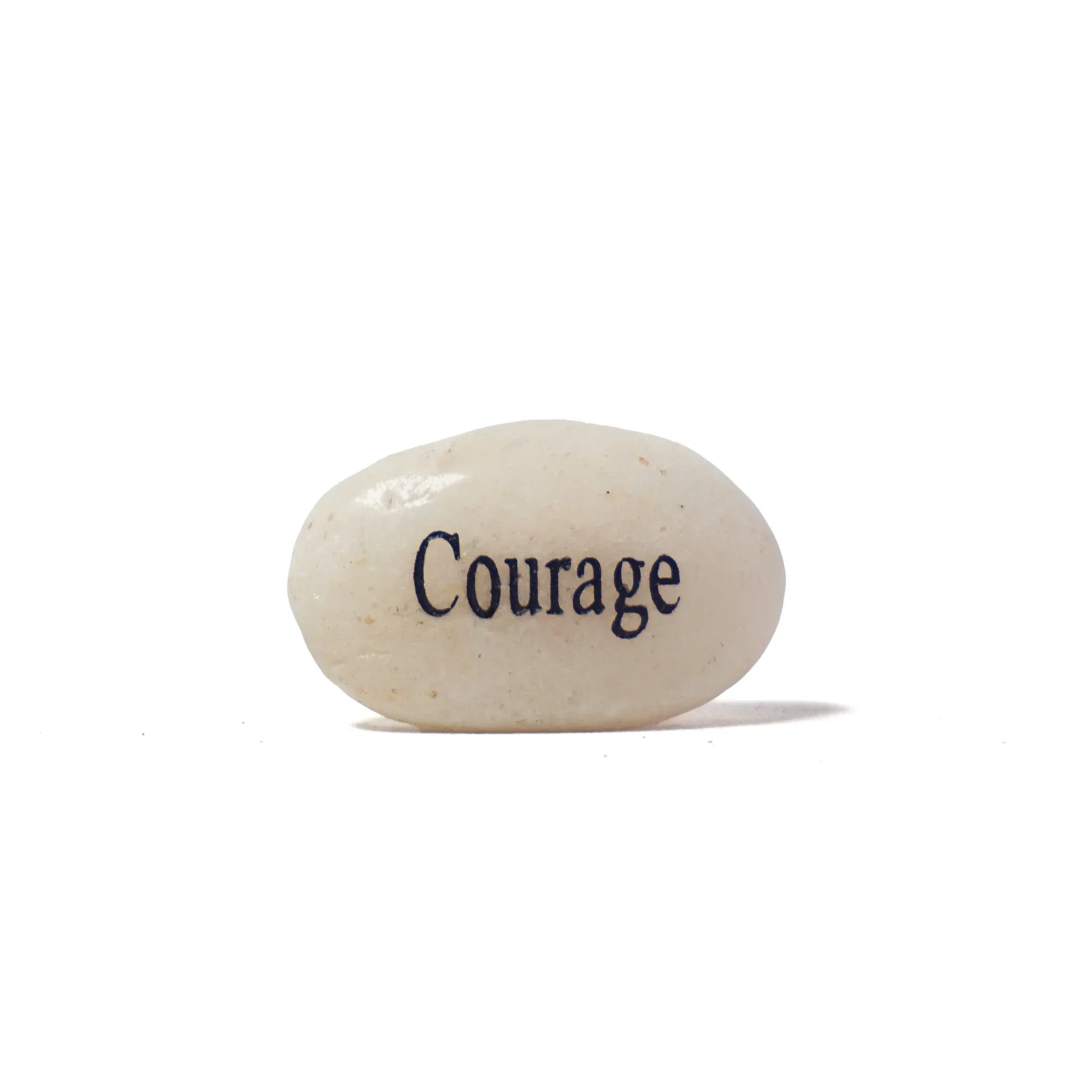 White stone with 'Courage' engraved on a white background