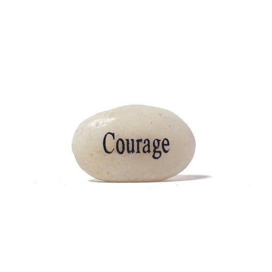 White stone with 'Courage' engraved on a white background