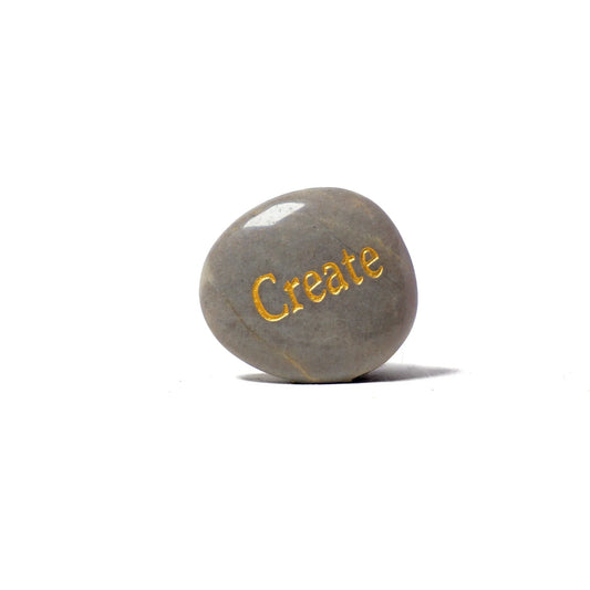 Gray stone with 'Create' engraved on a white background