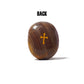 Brown stone with a gold cross on a white background