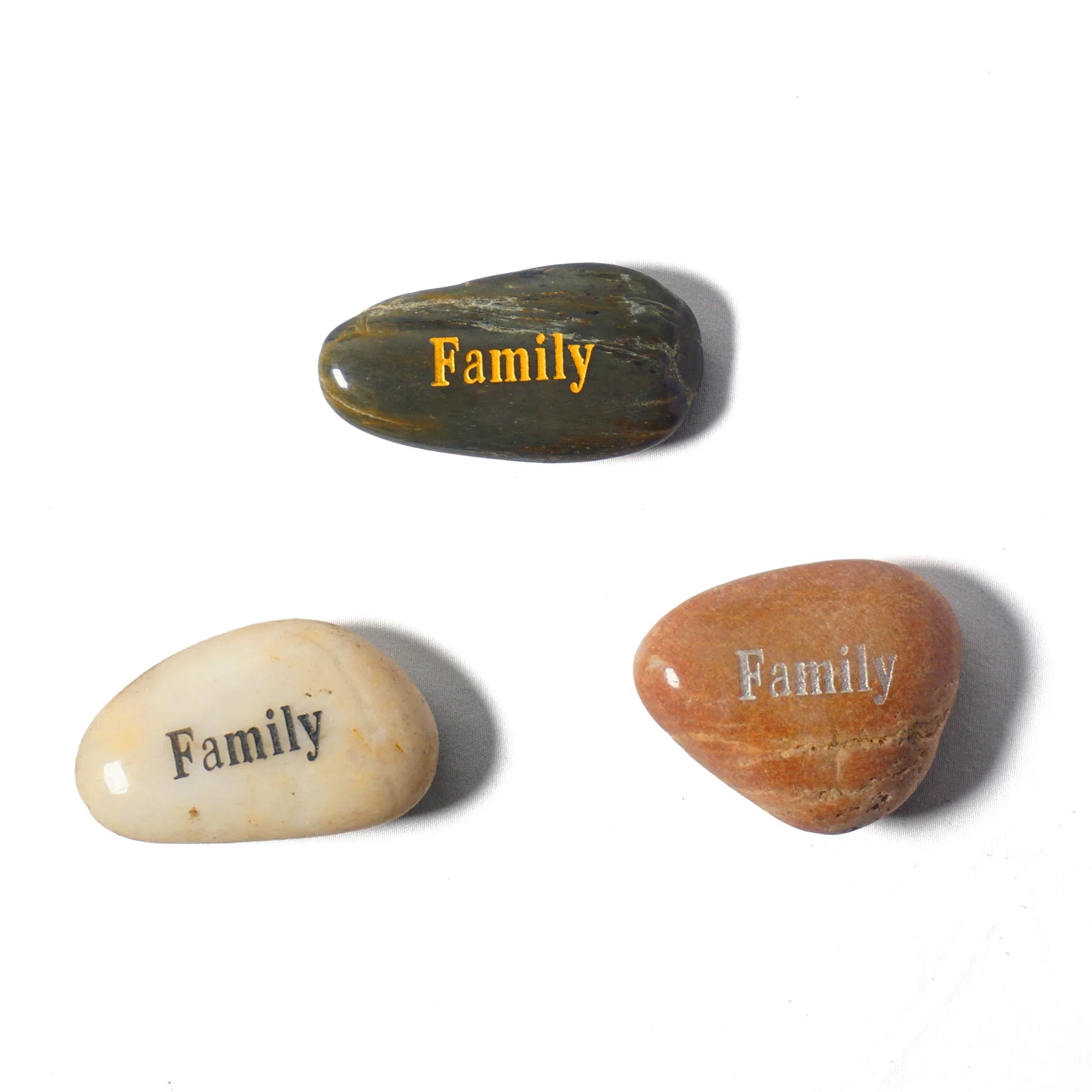 Three stones with 'Family' engraved on them on a white background