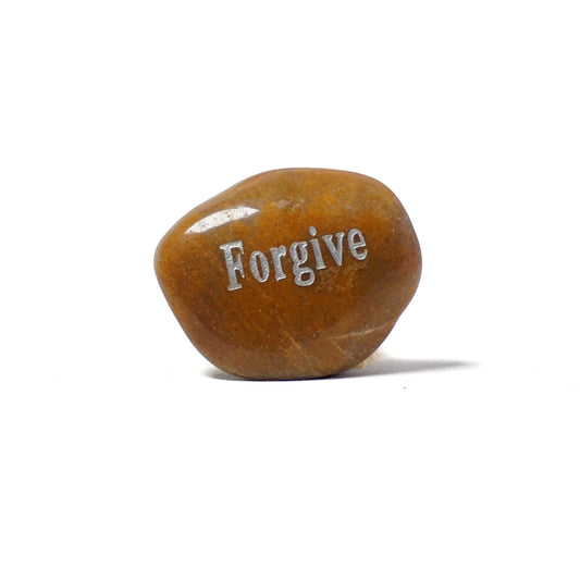 Brown stone with 'Forgive' engraved on a white background