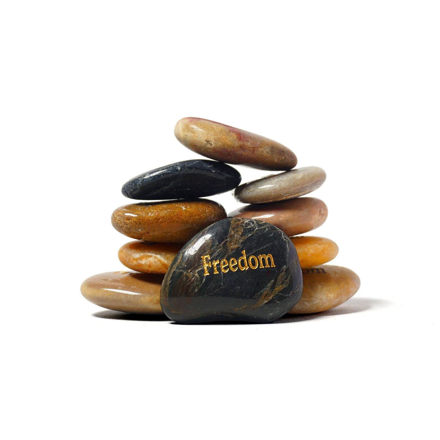 Stack of stones with 'Freedom' engraved on a white background