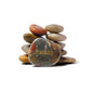 Stack of multicolored stones with 'Friendship' engraved on a white background