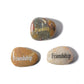 Three stones with 'Friendship' engraved on them on a white background