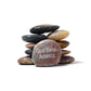 Stack of stones with 'God Bless America' engraved on a white background