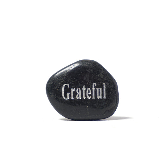 Black stone with 'Grateful' engraved on a white background