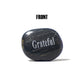 Black stone with 'Grateful' engraved on a white background
