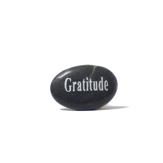 Black stone with 'Gratitude' engraved on a white background