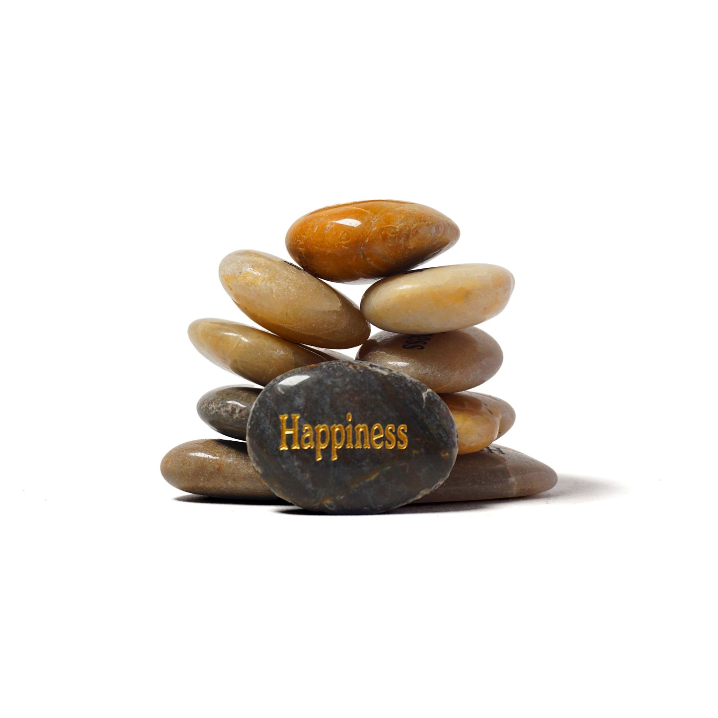 Stack of stones with a gold 'Happiness' text on a white background