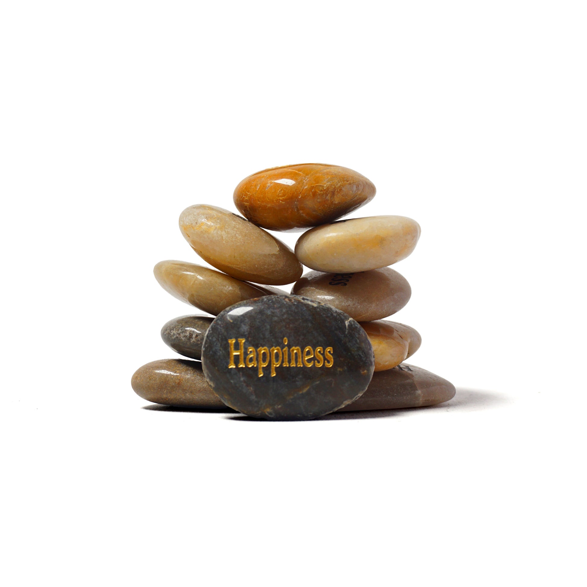 Stack of stones with a gold 'Happiness' text on a white background