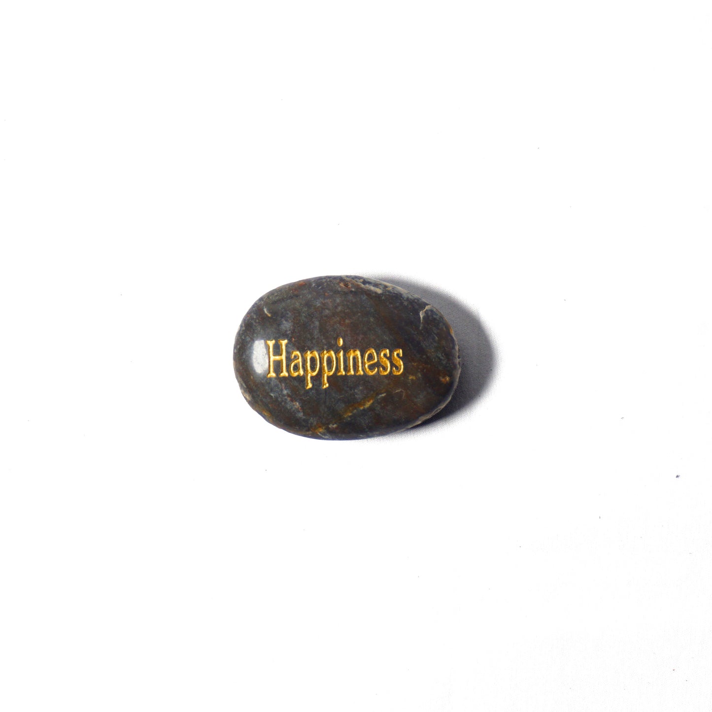 Rounded stone with 'Happiness' engraved on a white background