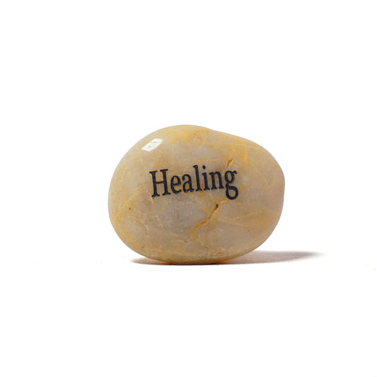 Round stone with 'Healing' engraved on a white background