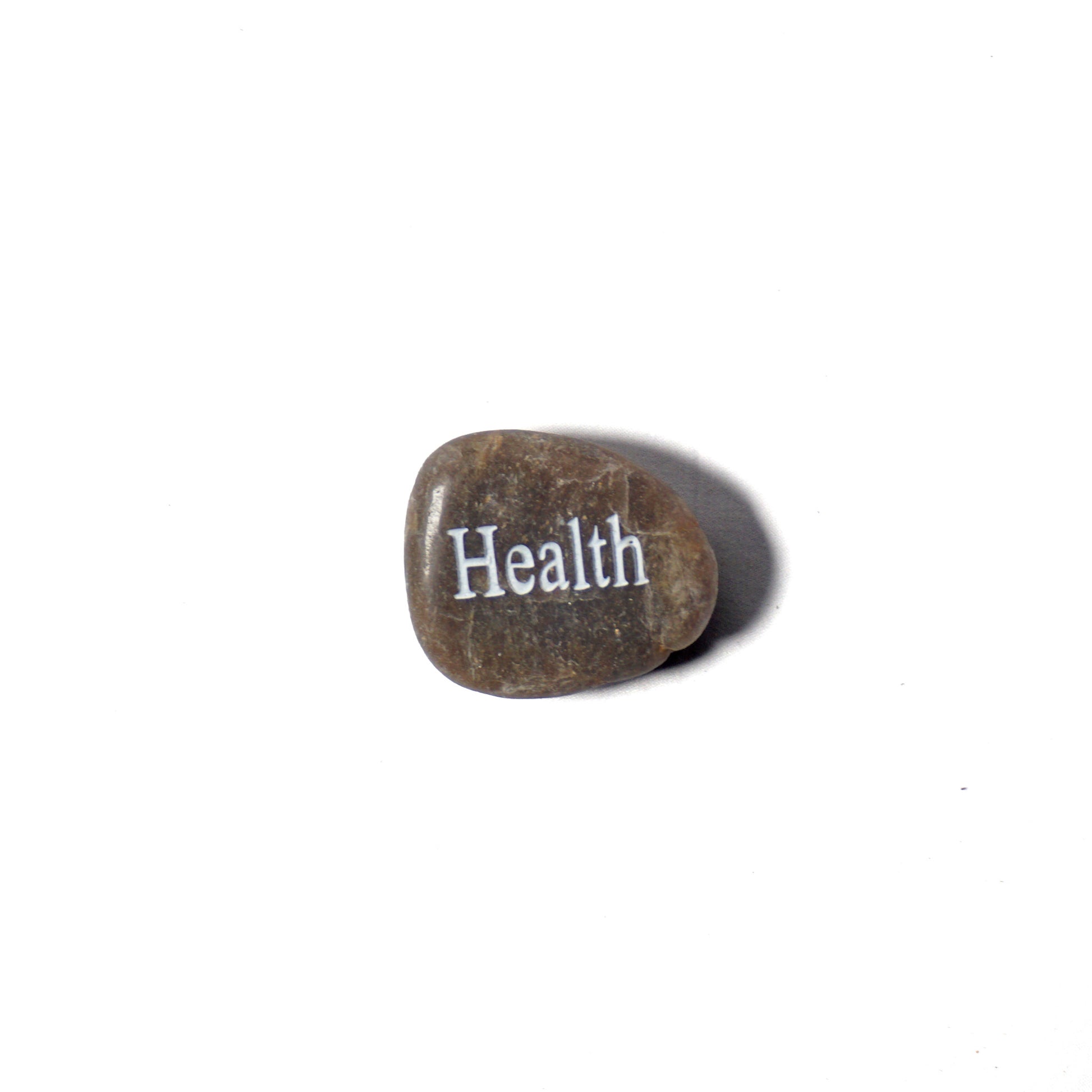 Rock with the word 'Health' engraved on a white background