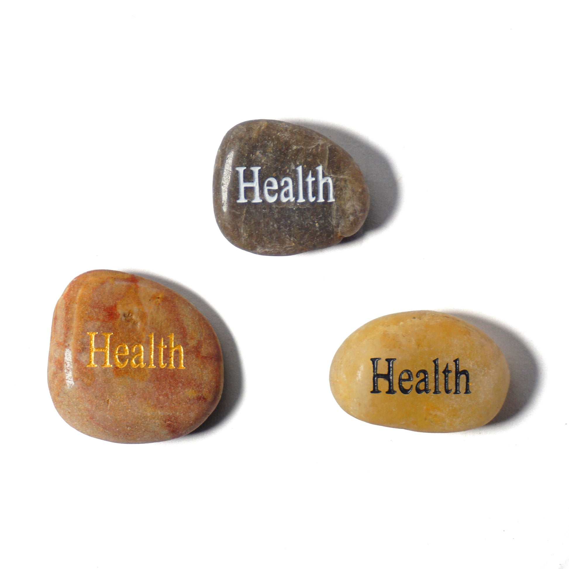 Three stones with the word 'Health' engraved on them, each in different colors.