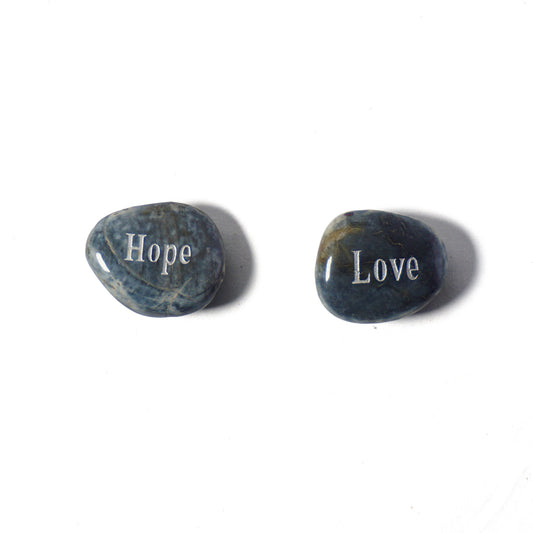 Two stones with 'Hope' and 'Love' engraved on a white background