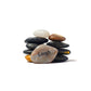 Stack of stones with a smaller stone on top, featuring the word 'Laugh'.