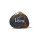 Decorative stone with 'Listen' engraved on a white background