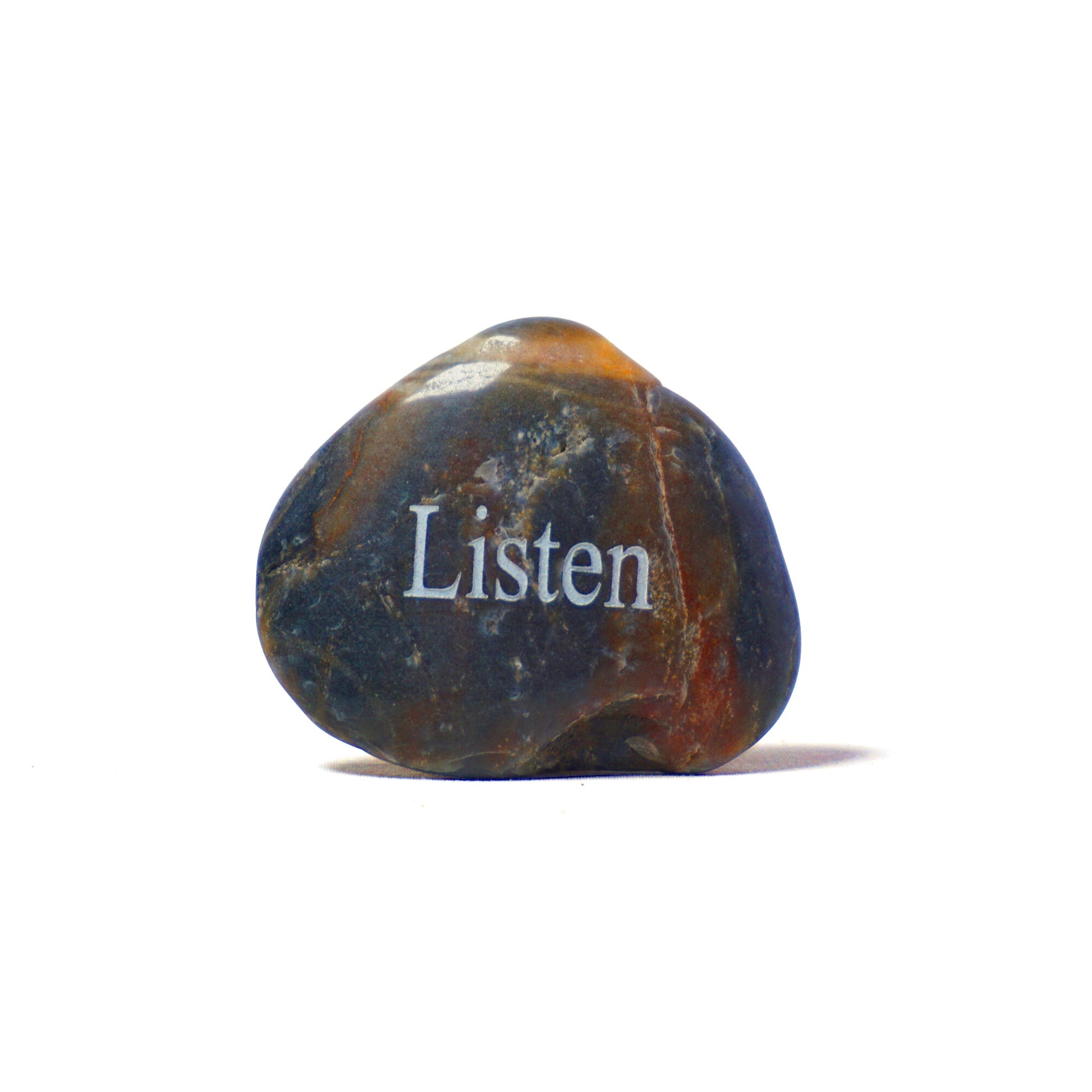 Decorative stone with 'Listen' engraved on a white background