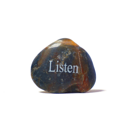 Decorative stone with 'Listen' engraved on a white background