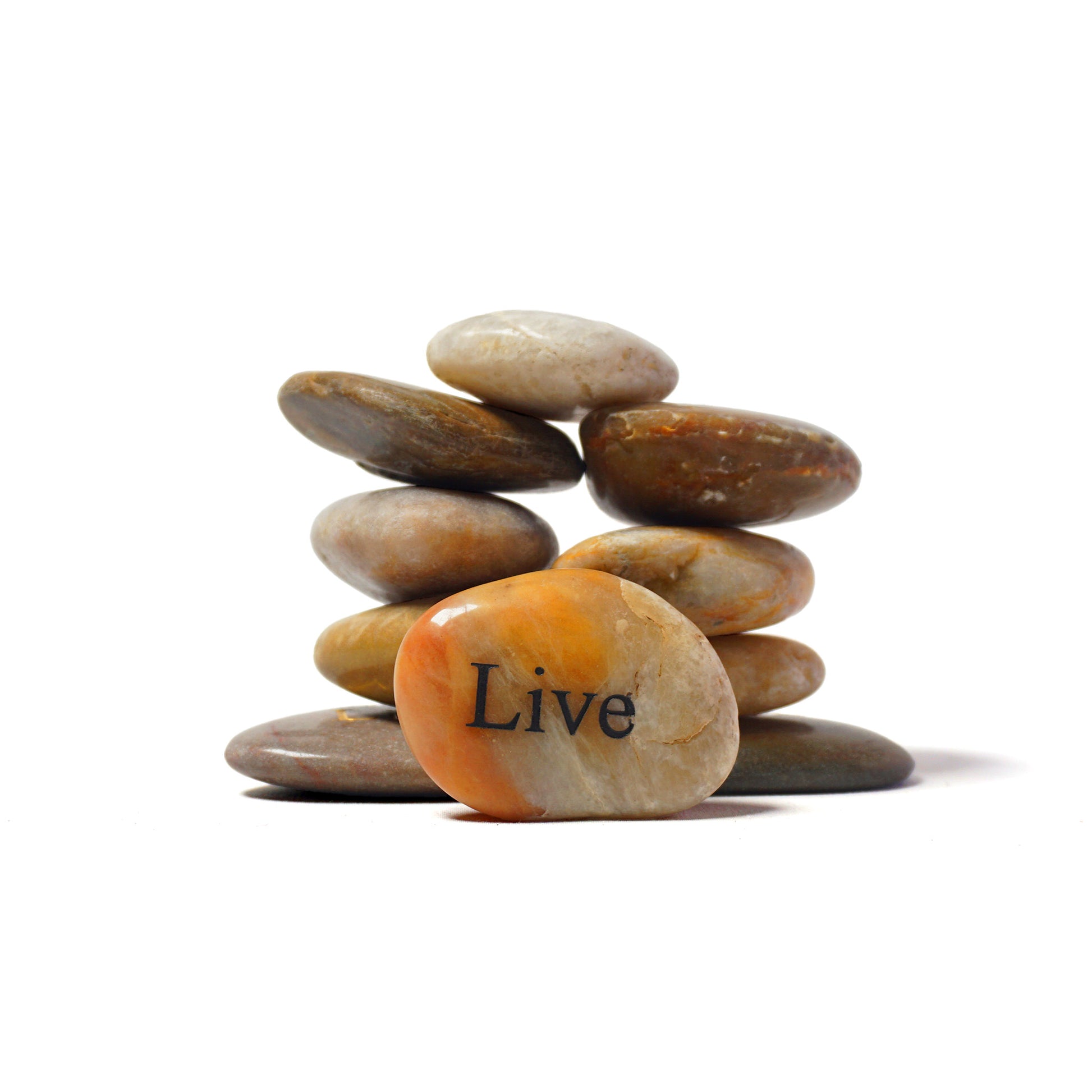Stack of stones with 'Live' engraved on one stone against a white background