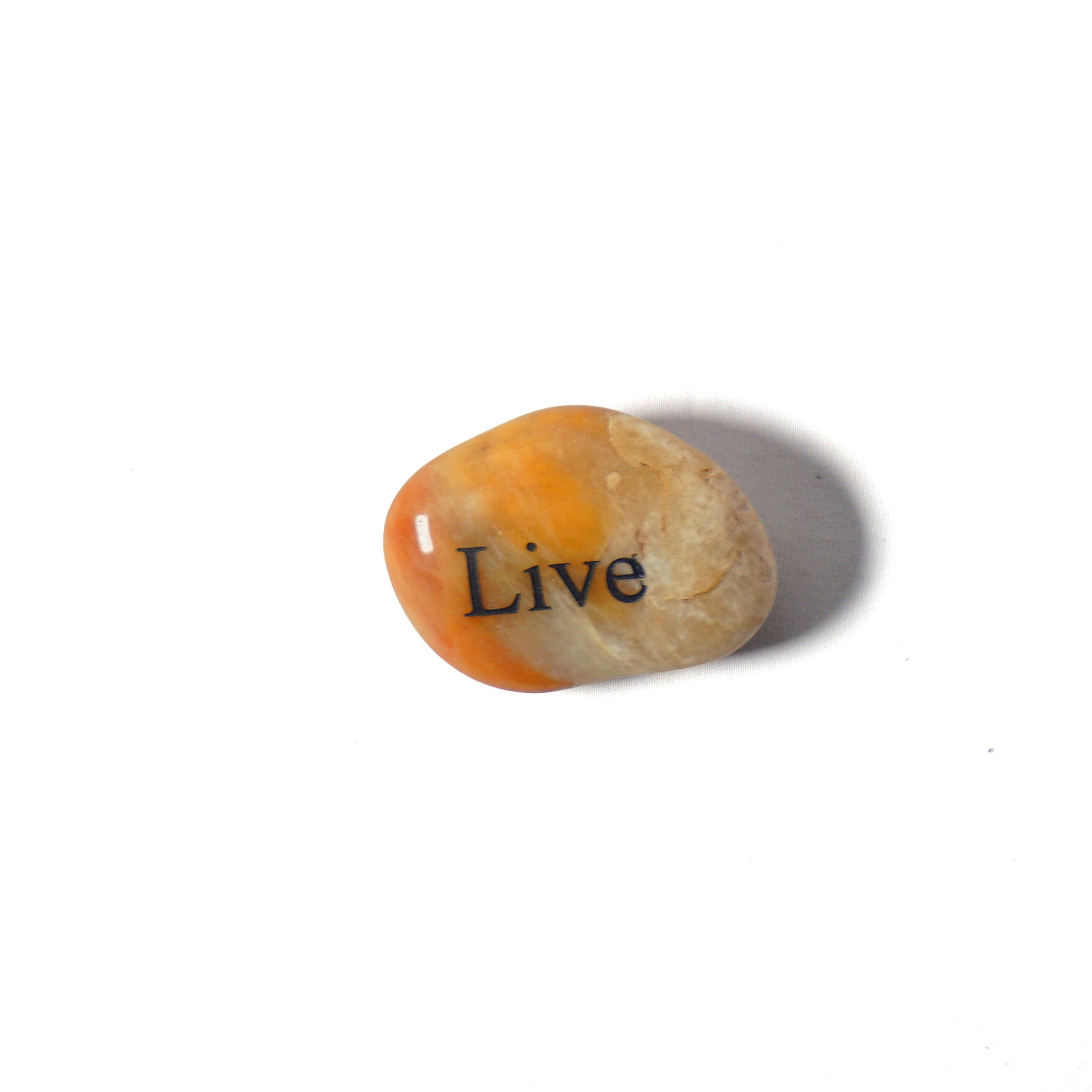 Decorative stone with 'Live' engraved on a white background